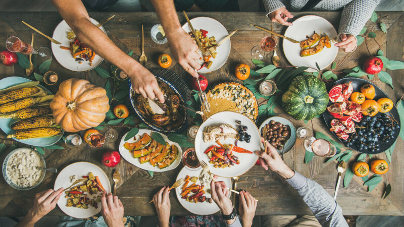 A table from above with Thanksgiving food all over it.