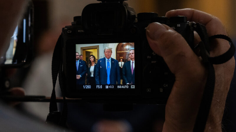 Trump being recorded in a camera.