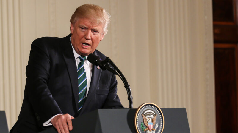 Trump speaking at a podium.