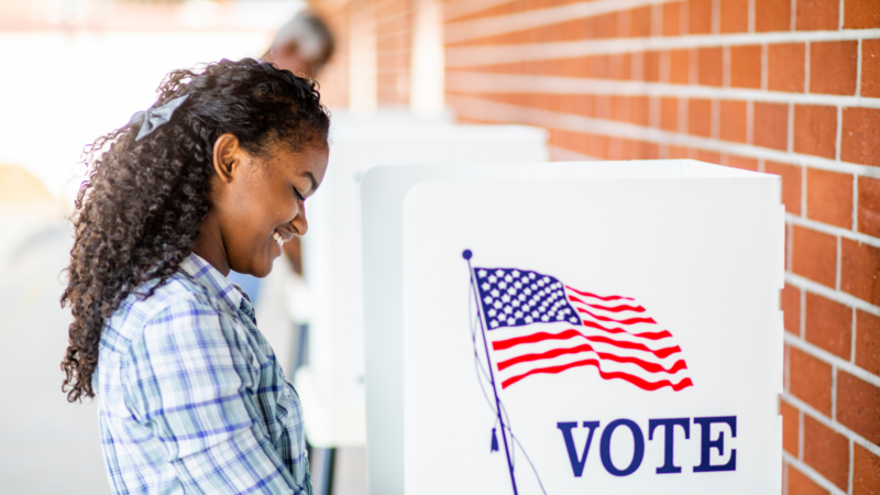 A woman voting at a polling location